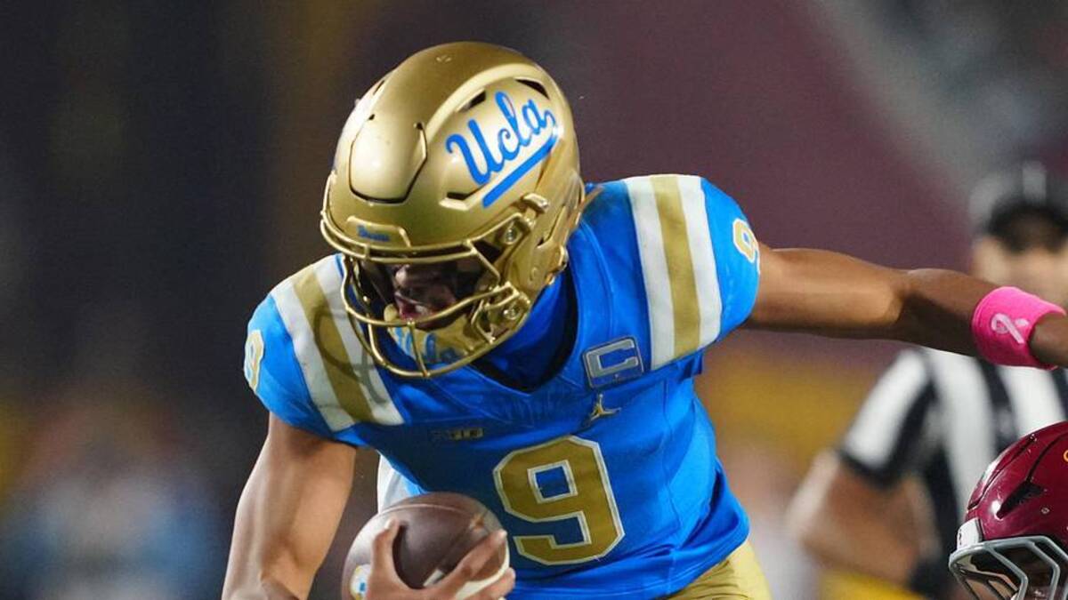  Nov 29, 2025; Los Angeles, California, USA; UCLA Bruins quarterback Nico Iamaleava (9) is tackled by Southern California Trojans linebacker Eric Gentry (18) in the second half at United Airlines Field at Los Angeles Memorial Coliseum. Mandatory Credit: Kirby Lee-Imagn Images | Kirby Lee-Imagn Images 