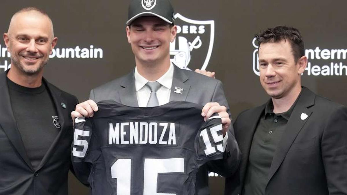  Apr 24, 2026; Henderson, NV, USA; Las Vegas Raiders quarterback Fernando Mendoza (center) poses with general manager John Spytek (left) and head coach Klint Kubiak at introductory press conference at Intermountain Health Performance Center after being selected as the No. 1 pick in the 2026 NFL Draft. Mandatory Credit: Kirby Lee-Imagn Images | Kirby Lee-Imagn Images 