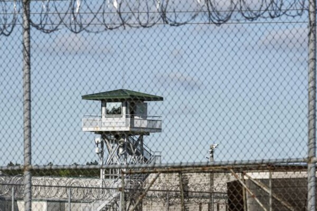 FILE - In this April 16, 2018, file photo, a guard tower stands above the Lee Correctional Institution, a maximum security prison in Bishopville, S.C., the morning after several inmates were killed amid fighting among prisoners. South Carolina officials hope they can combat the dangers of illegal cellphones behind bars by providing inmates with a different kind of technological device. Corrections Director Bryan Stirling tells The Associated Press Thursday, Jan. 17, 2019, he’s going to start handing out tablet computers that inmates can use for calling family members, watching movies and studying educational materials.