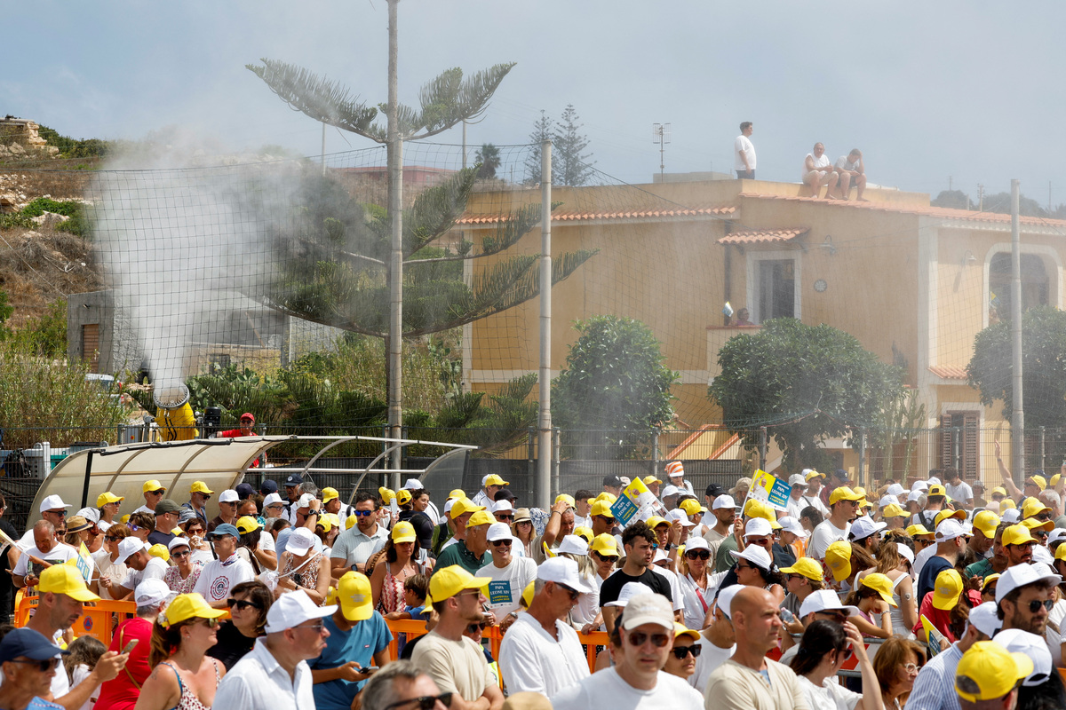 A mist is dispensed to cool off faithful gathered for the Holy Mass celebrated with Pope Leo, as he visits the island of Lampedusa, a key entry point for migrants crossing the Mediterranean Sea, during a pastoral trip, Italy, July 4, 2026. REUTERS/Remo Casilli