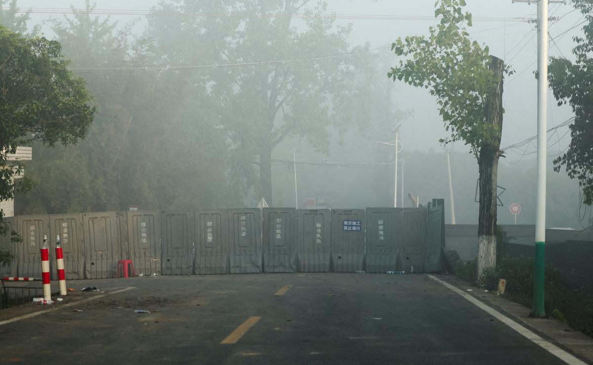 A barrier blocks a road near the site of a blast at a fireworks manufacturing factory in Liuyang, Hunan province, China, May 6, 2026. REUTERS/Maxim Shemetov