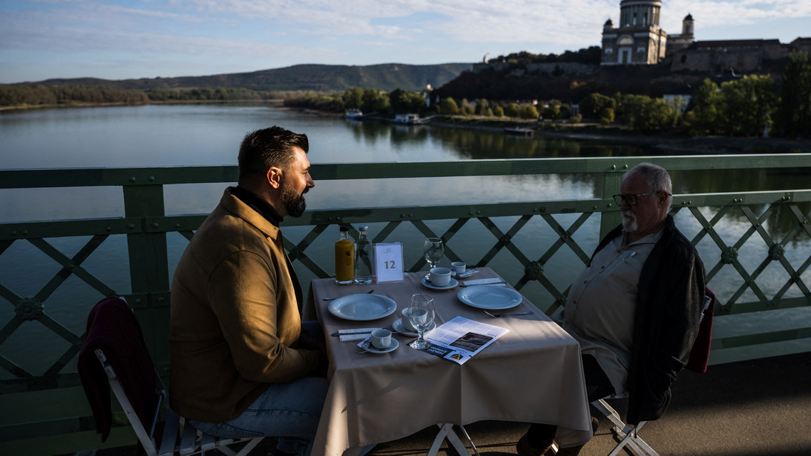 Hungarians and Slovaks share breakfast on Danube bridge that survived war and division 