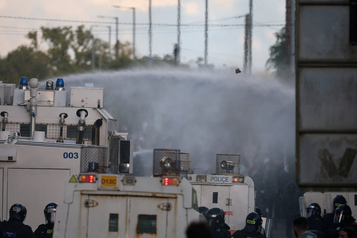 Police use a water cannon on anti-immigrant protesters, following a knife attack on June 8, which left a man seriously injured and prompted police to declare a critical incident, in Belfast, Northern Ireland, June 10, 2026. REUTERS/Isabel Infantes