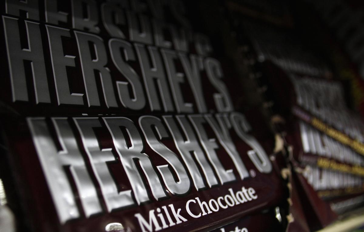 Hershey's candy bars are displayed at a gas station in Phoenix, Arizona October 27, 2011. Hershey Co said sales and earnings growth would slow next year, as costs for ingredients remain high, sending its shares down 4 percent. The company, whose shares have outperformed its peers this year, forecast 2012 sales and earnings growth in line with its long-term targets, which call for increases of 3 percent to 5 percent for sales and 6 to 8 percent for earnings. REUTERS/Joshua Lott (UNITED STATES - Tags: BUSINESS FOOD)