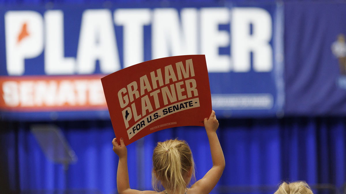 A young supporter displays a campaign sign at the Primary Election event for Democratic U.S. Senate candidate Graham Platner on June 9 in Blue Hill, Maine.
