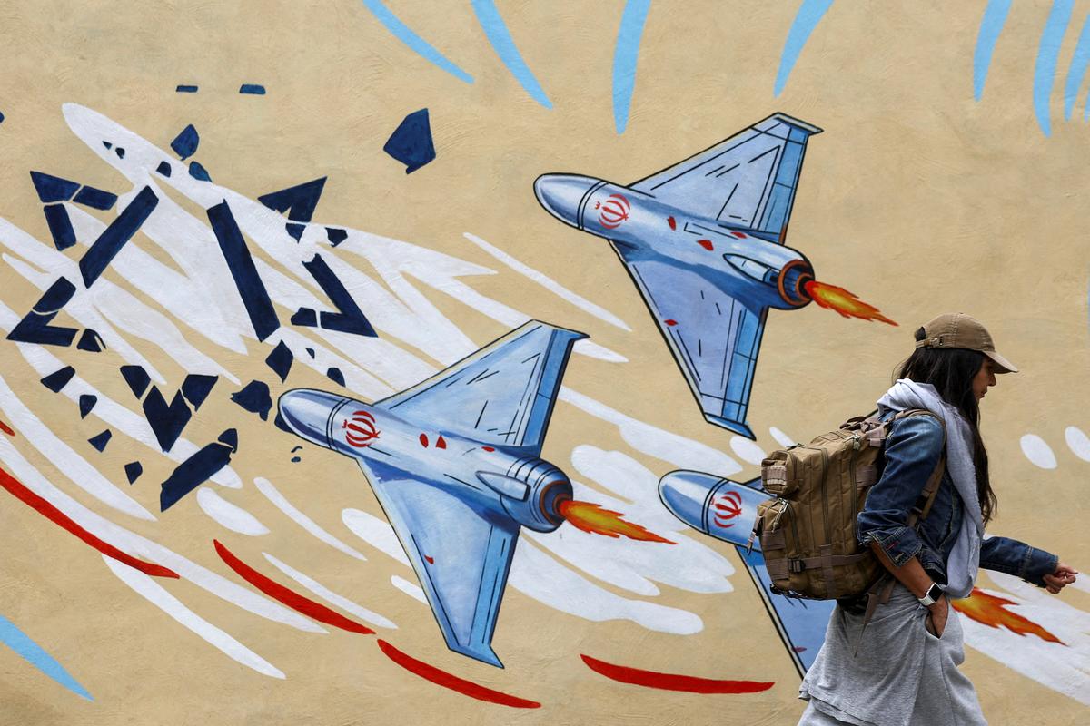 An Iranian woman walks next to an anti-Israeli mural on a street in Tehran, Iran, May 5, 2026. Majid Asgaripour/WANA (West Asia News Agency) via REUTERS