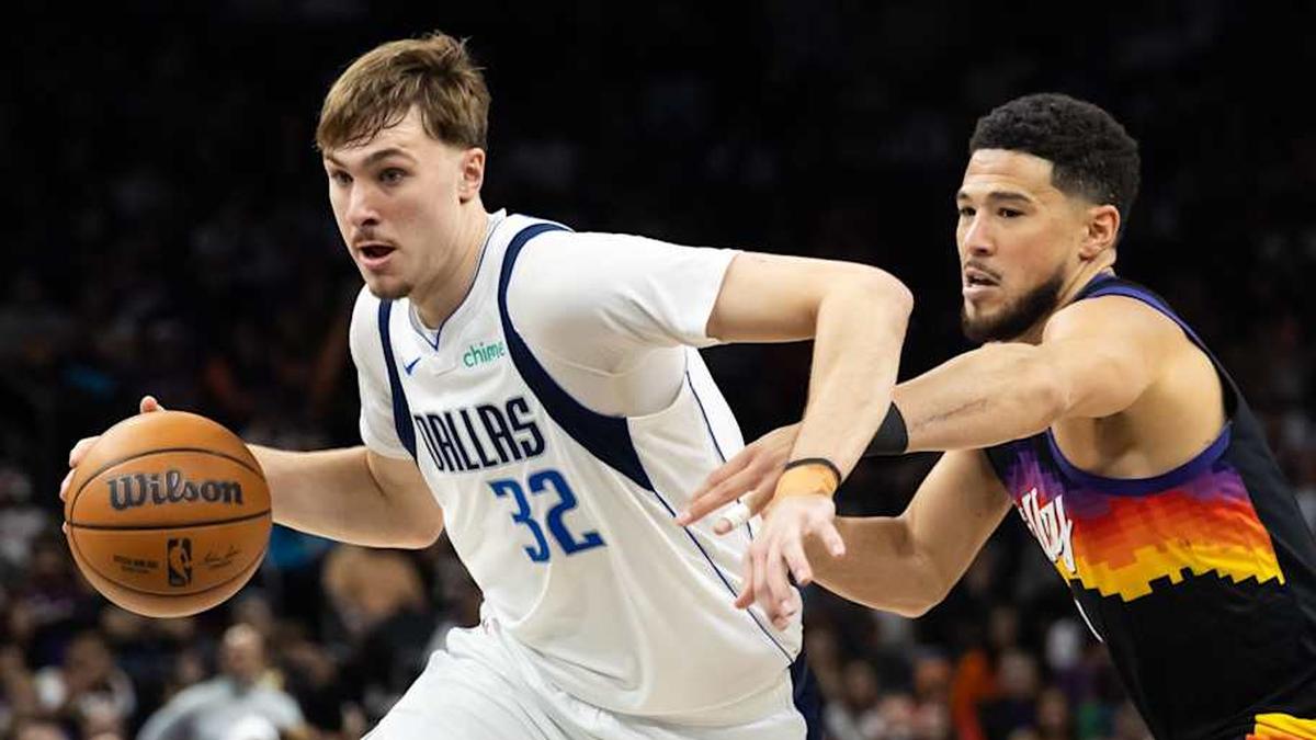  Apr 8, 2026; Phoenix, Arizona, USA; Dallas Mavericks forward Cooper Flagg (32) moves the ball against Phoenix Suns guard Devin Booker (1) in the second half at Mortgage Matchup Center. Mandatory Credit: Mark J. Rebilas-Imagn Images | Mark J. Rebilas-Imagn Images 