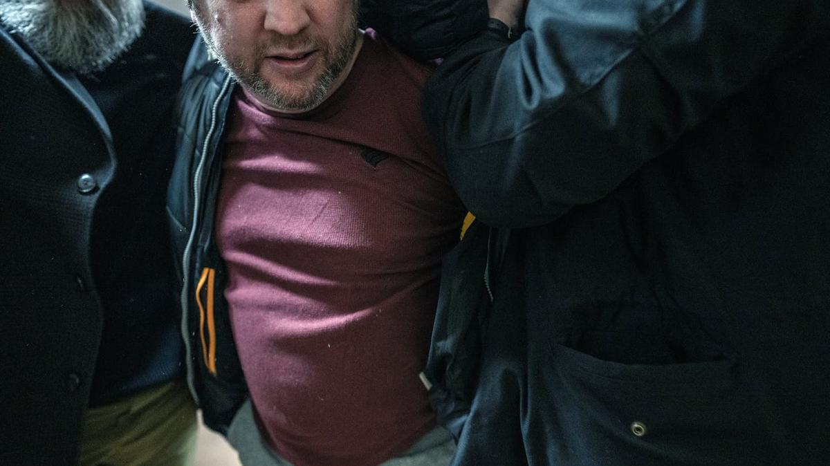 Rep. Ilhan Omar's security detail subdues Anthony Kazmierczak after he sprayed her with vinegar on Jan. 27. (Richard Tsong-Taatarii/The Minnesota Star Tribune/TNS)