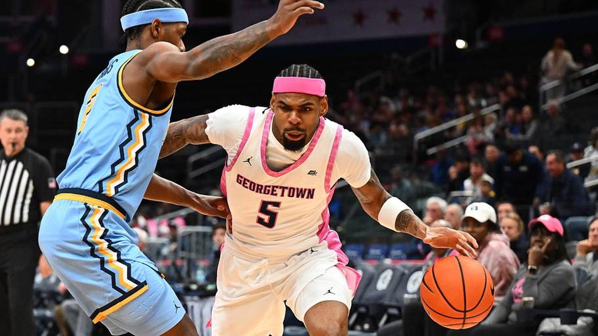  Feb 24, 2026; Washington, District of Columbia, USA; Georgetown Hoyas guard KJ Lewis (5) dribbles as Marquette Golden Eagles guard Chase Ross (2) defends during the first half at Capital One Arena. Mandatory Credit: Brad Mills-Imagn Images | Brad Mills-Imagn Images 