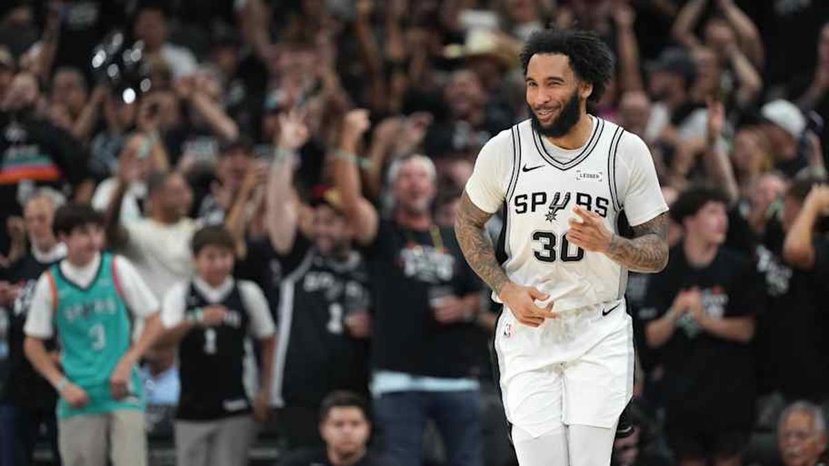  Apr 28, 2026; San Antonio, Texas, USA; San Antonio Spurs forward Julian Champagnie (30) reacts after scoring a three point basket during the second half of game five of the first round of the 2026 NBA Playoffs against the Portland Trail Blazers at Frost Bank Center. | Scott Wachter-Imagn Images 