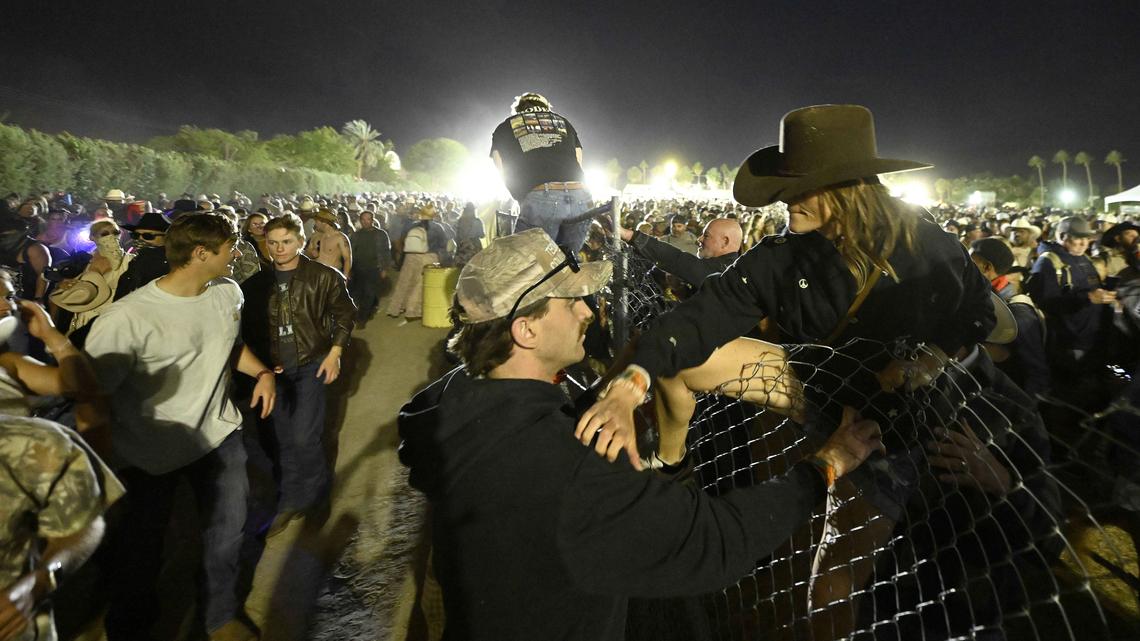 Country music fans climb over a fence as they evacuate for safety from the Empire Polo Club as high winds of approximately 50 mph battered the second day of the Stagecoach Country Music Festival in Indio on Saturday, April 25, 2026. The venue was reopend to fans less than hour later. (Photo by Will Lester, Inland Valley Daily Bulletin/SCNG)