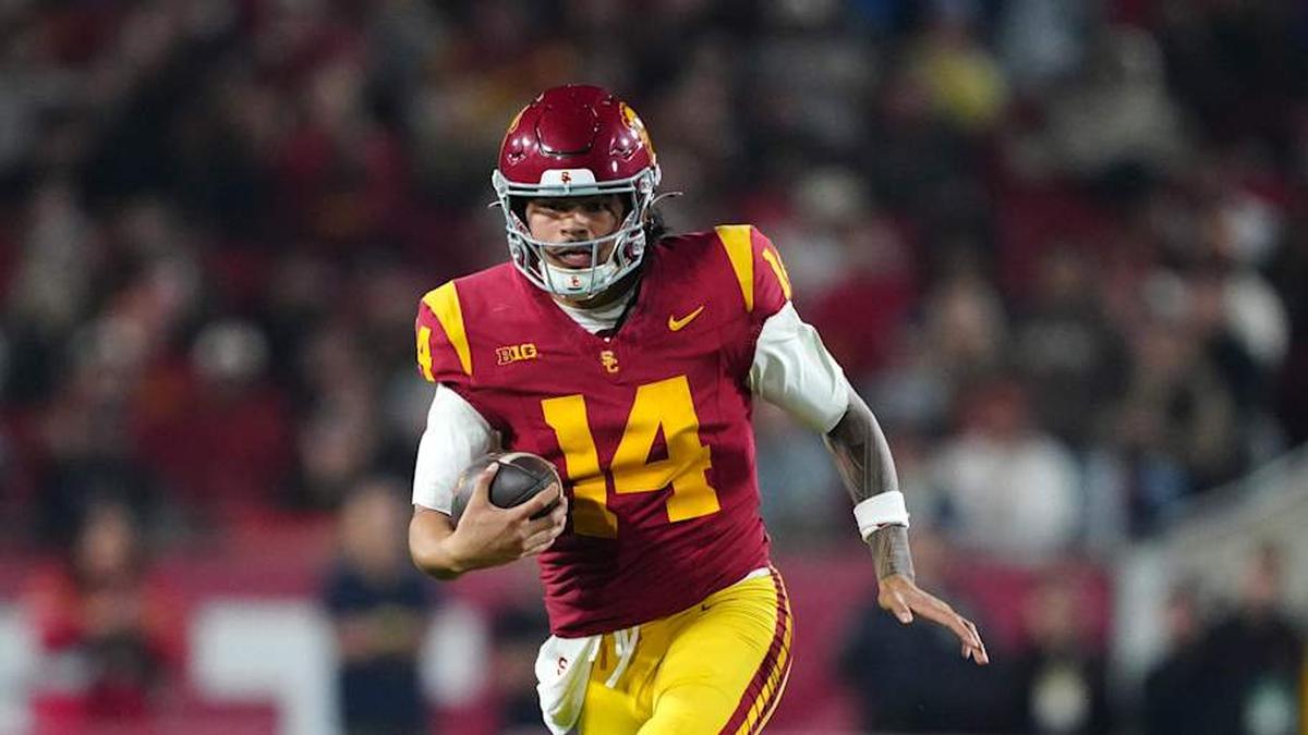  Nov 29, 2025; Los Angeles, California, USA; Southern California Trojans quarterback Jayden Maiava (14) carries the ball against the UCLA Bruins in the first half at United Airlines Field at Los Angeles Memorial Coliseum. Mandatory Credit: Kirby Lee-Imagn Images | Kirby Lee-Imagn Images 