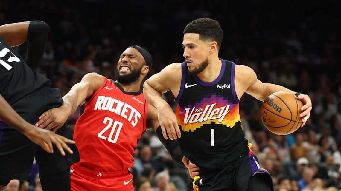  Apr 7, 2026; Phoenix, Arizona, USA; Phoenix Suns guard Devin Booker (1) drives to the basket against Houston Rockets guard Josh Okogie (20) in the second half at Mortgage Matchup Center. | Mark J. Rebilas-Imagn Images 