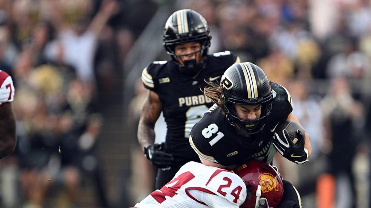  Sep 13, 2025; West Lafayette, Indiana, USA; Purdue Boilermakers tight end George Burhenn (81) is tackled by Southern California Trojans safety Christian Pierce (24) during the first quarter at Ross-Ade Stadium. Mandatory Credit: Marc Lebryk-Imagn Images | Marc Lebryk-Imagn Images 