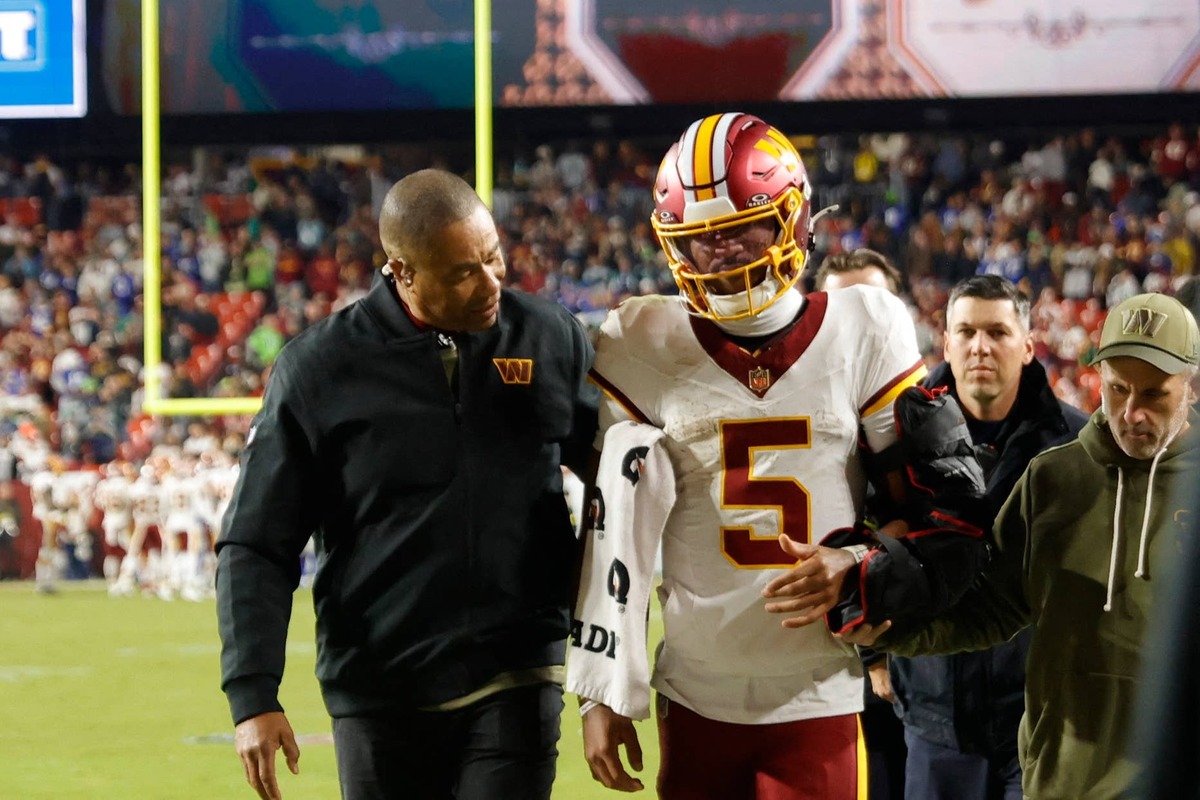  Nov 2, 2025; Landover, Maryland, USA; Washington Commanders quarterback Jayden Daniels (5) is helped off the field after an injury during the second half against the Seattle Seahawks at Northwest Stadium. Mandatory Credit: Amber Searls-Imagn Images