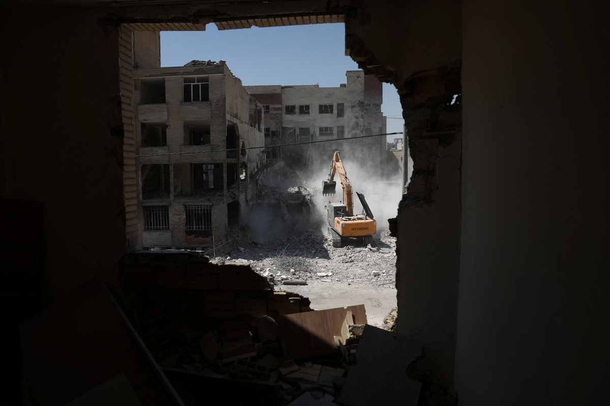A machine operates near a residential building, which was damaged in a U.S. and Israeli strike in March, in Tehran, Iran June 7, 2026. Majid Asgaripour/WANA (West Asia News Agency) via REUTERS