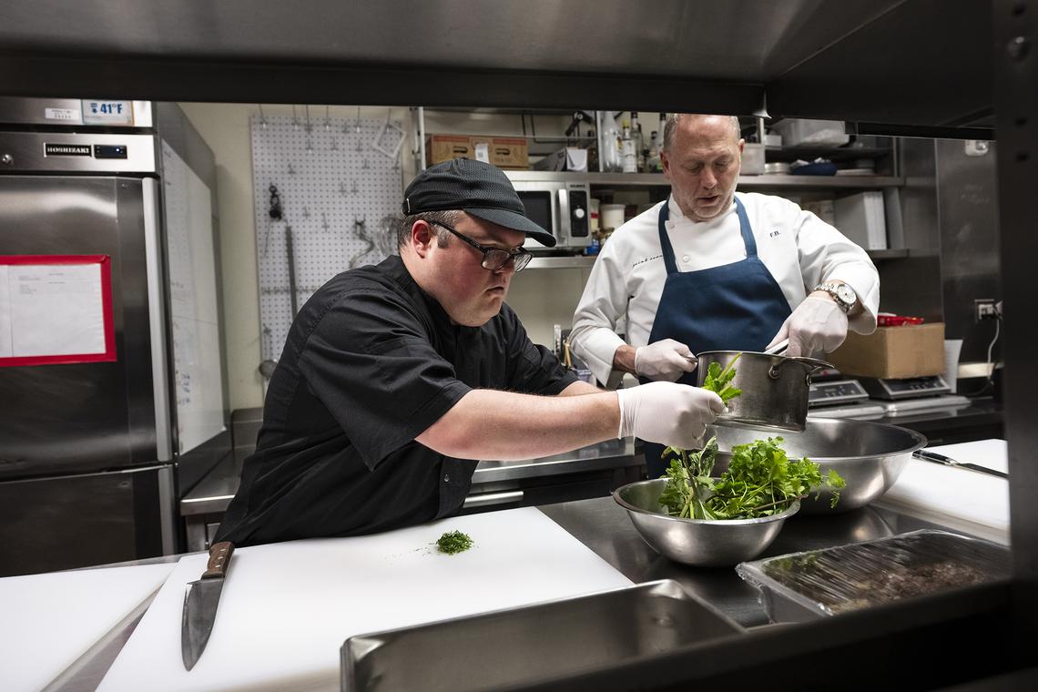 Joseph Valentino, left, a cook at Point Seven in Manhattan, and Franklin Becker, the restaurant's owner, on March 29, 2026. Culinary jobs have the potential to be a perfect fit, and a new effort is afoot to help autistic workers land them. (James Estrin/The New York Times)