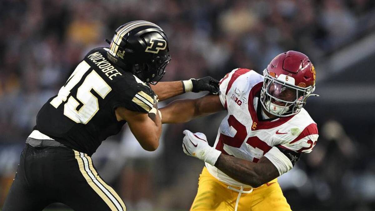  Sep 13, 2025; West Lafayette, Indiana, USA; Purdue Boilermakers running back Devin Mockobee (45) fights to get past USC Trojans linebacker Desman Stephens II (23) during the second quarter at Ross-Ade Stadium. Mandatory Credit: Marc Lebryk-Imagn Images | Marc Lebryk-Imagn Images 