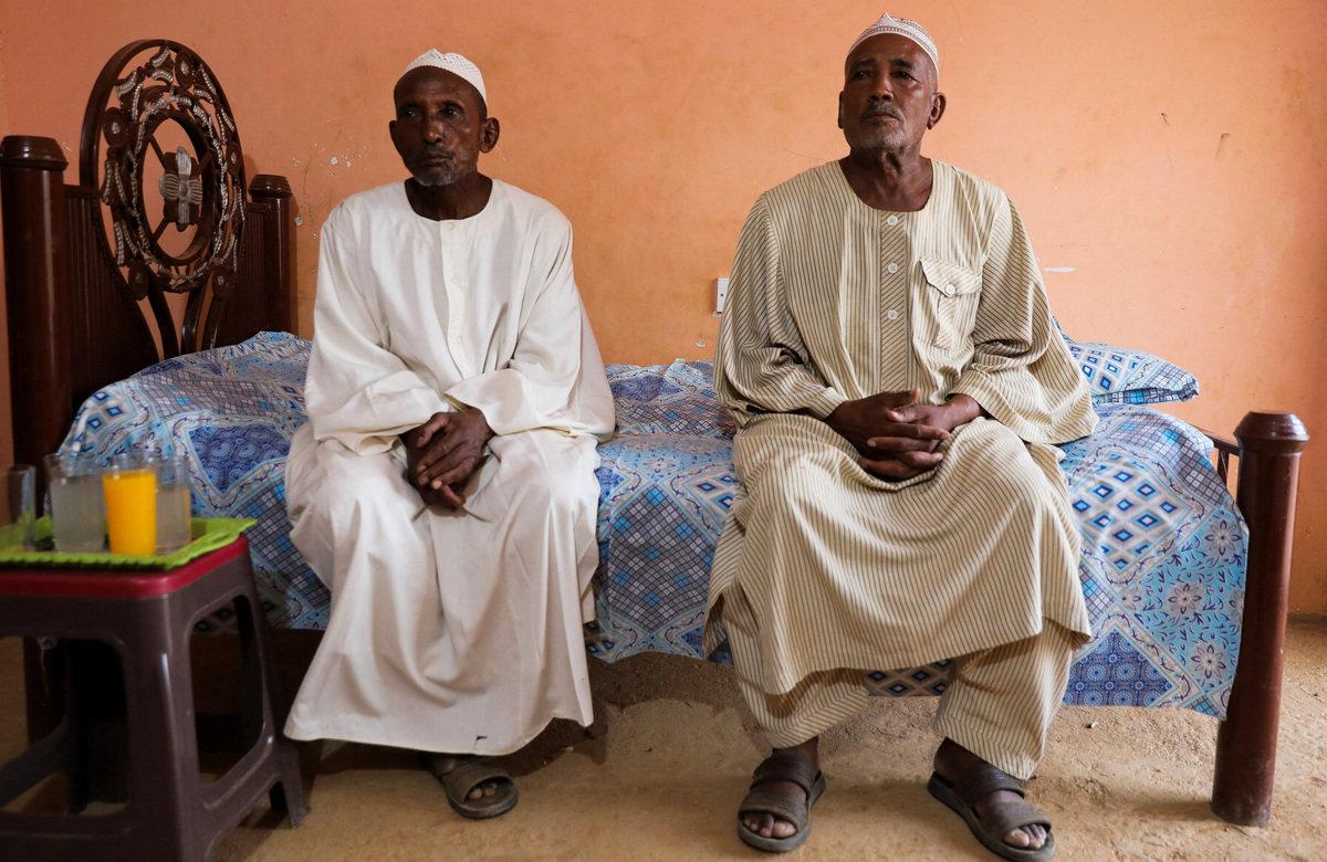 Parents of victims mass-murdered by the Rapid Support Forces (RSF) sit on a bed during an interview in the Salha area, south of Omdurman, Sudan, June 7, 2026. REUTERS/Stringer