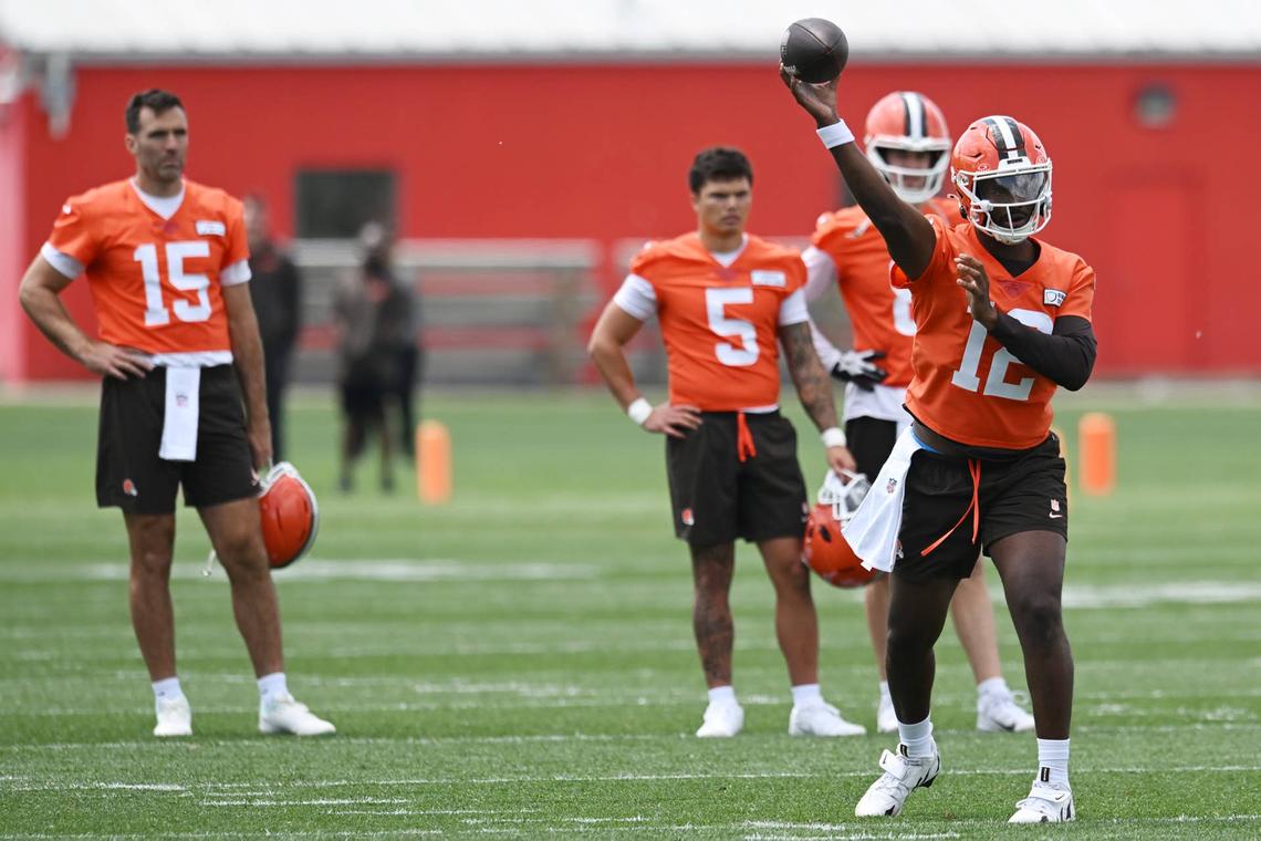  Jun 10, 2025; Berea, OH, USA; Cleveland Browns quarterback Shedeur Sanders (12) throws a pass as quarterback Joe Flacco (15) and quarterback Dillon Gabriel (5) and quarterback Kenny Pickett (8) look on during minicamp at CrossCountry Mortgage Campus. 