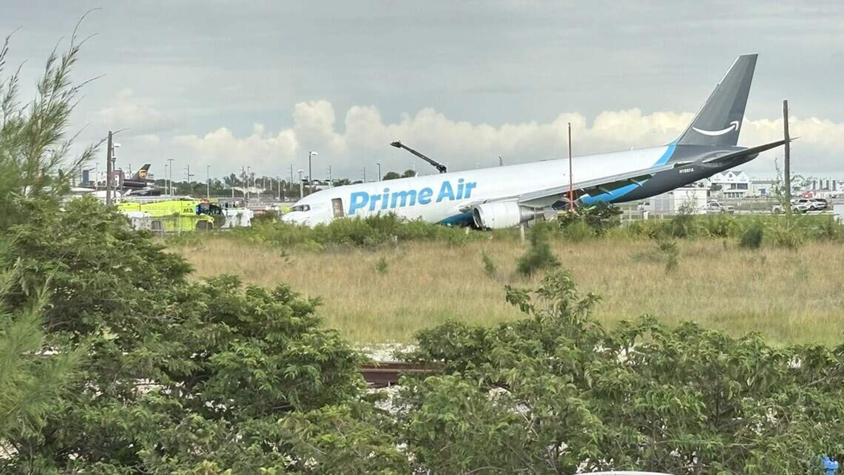 NTSB says Amazon cargo jet hit van, car after runway overrun