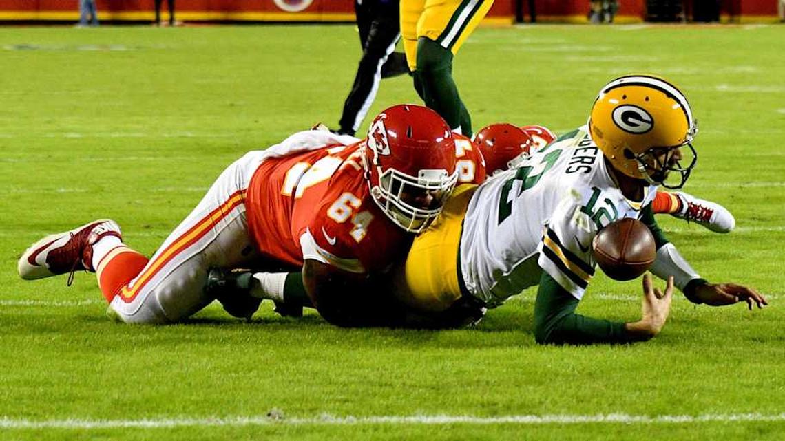  Oct 27, 2019; Kansas City, MO, USA; Green Bay Packers quarterback Aaron Rodgers (12) runs the ball and is tackled by Kansas City Chiefs defensive tackle Mike Pennell (64) during the second half at Arrowhead Stadium. Mandatory Credit: Denny Medley-Imagn Images | Denny Medley-Imagn Images 