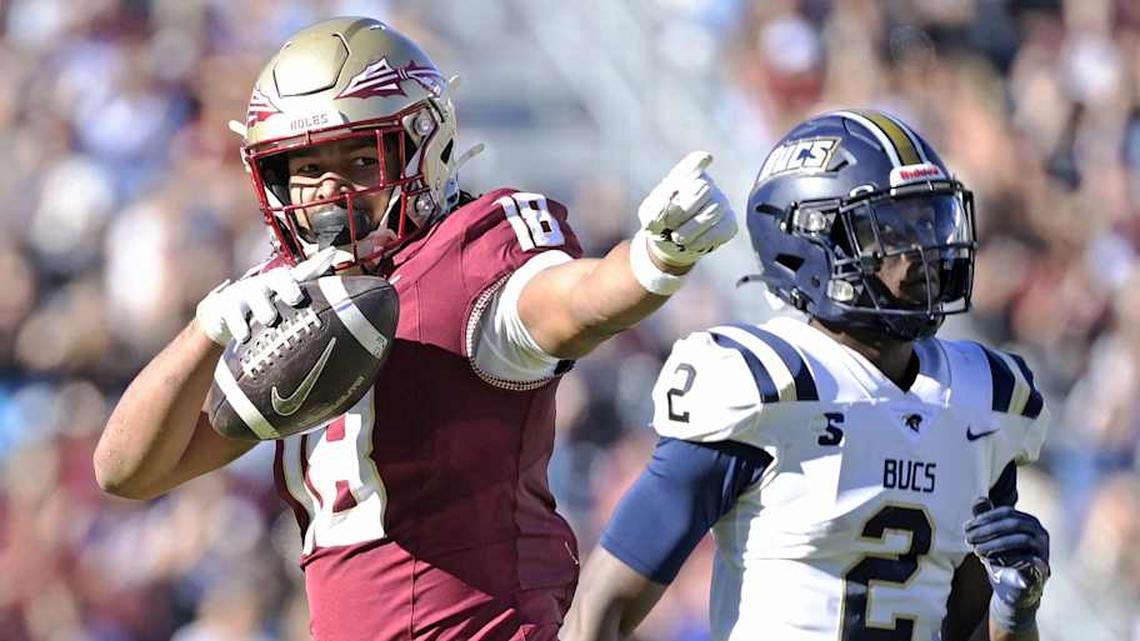 Nov 23, 2024; Tallahassee, Florida, USA; Florida State Seminoles tight end Landen Thomas (18) celebrates a first down grab as Charleston Southern Buccaneers safety Davion Williams (2) looks on during the second half of the game at Doak S. Campbell Stadium. Mandatory Credit: Melina Myers-Imagn Images | Melina Myers-Imagn Images 
