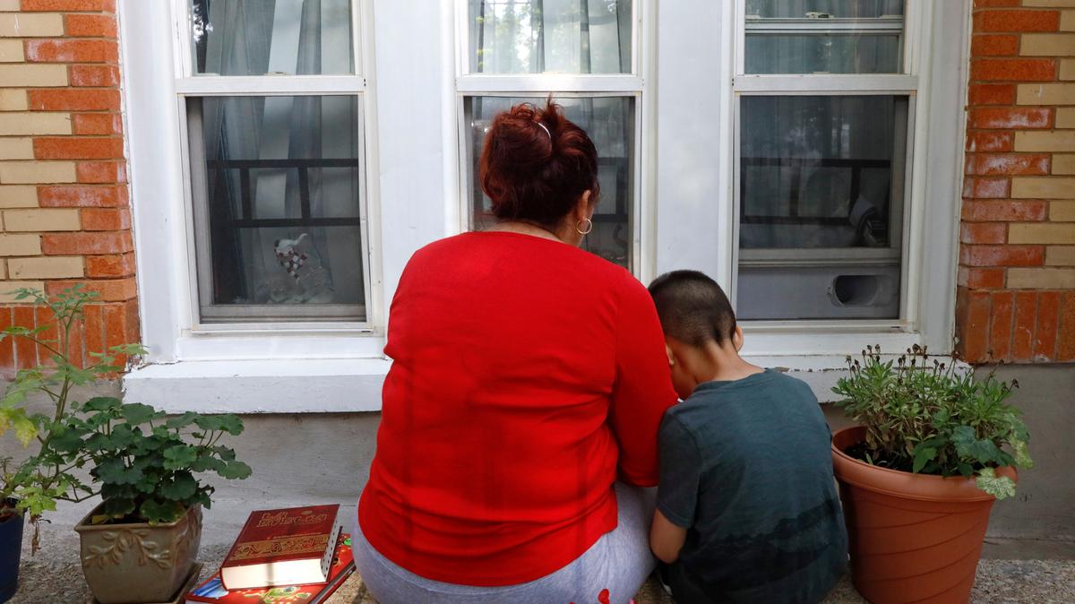 Eugenia Rodriguez shares a moment with her youngest son, Aaron, 6, while reading a children’s book on July 2 in Chicago.