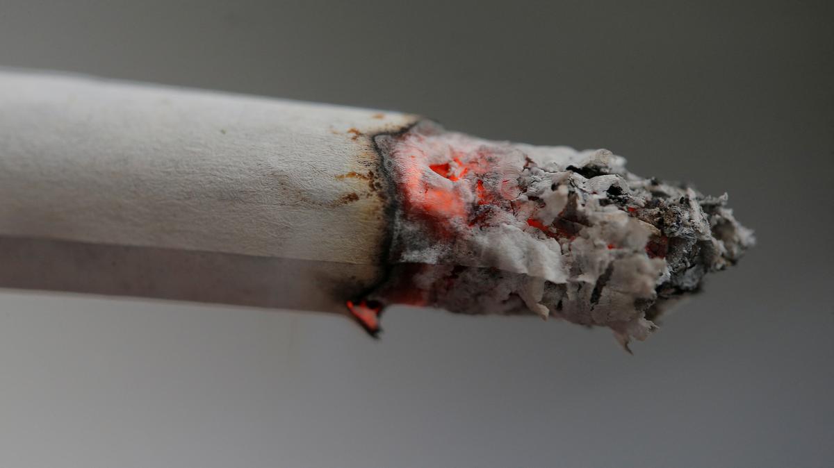 FILE PHOTO: A cigarette burns as an office worker takes a break in Sydney, Australia, May 11, 2017.  REUTERS/Jason Reed/File Photo
