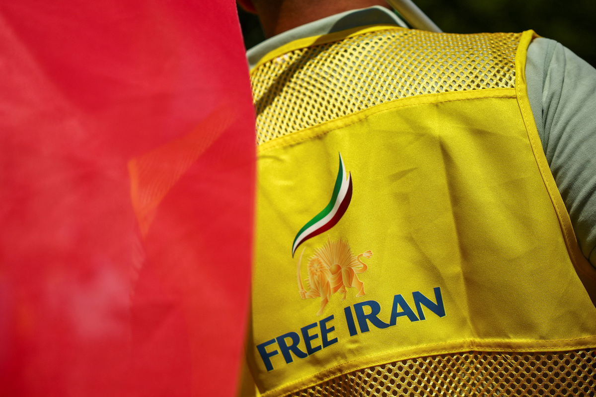 A man wears a jacket reading "Free Iran" and with a pre-Iranian Revolution "Lion and Sun" national emblem during a demonstration against political executions in Iran and in support of a democratic republic, a demonstration which was banned by Paris Police Prefecture, in Paris, France, June 20, 2026. REUTERS/Sarah Meyssonnier