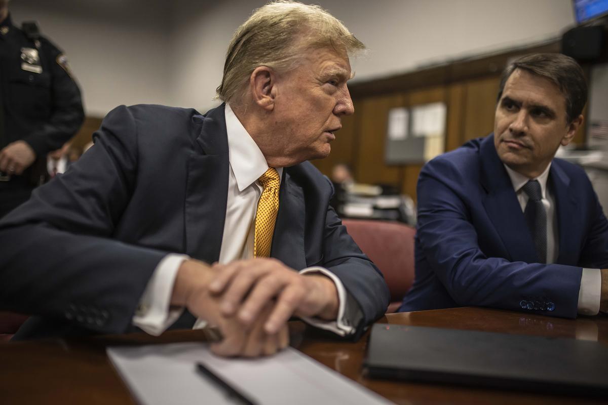 FILE -- Then former President Donald Trump speaks with his attorney, Todd Blanche, before the start of the day's proceedings during his criminal trial in New York, May 21, 2024. The Justice Department announced on Monday, May 18, 2026, that it was setting up a new $1.8 billion fund to compensate people who it said were victims of "weaponization and lawfare," a group that will almost certainly be made up of President Trump's political allies. (Dave Sanders/The New York Times)