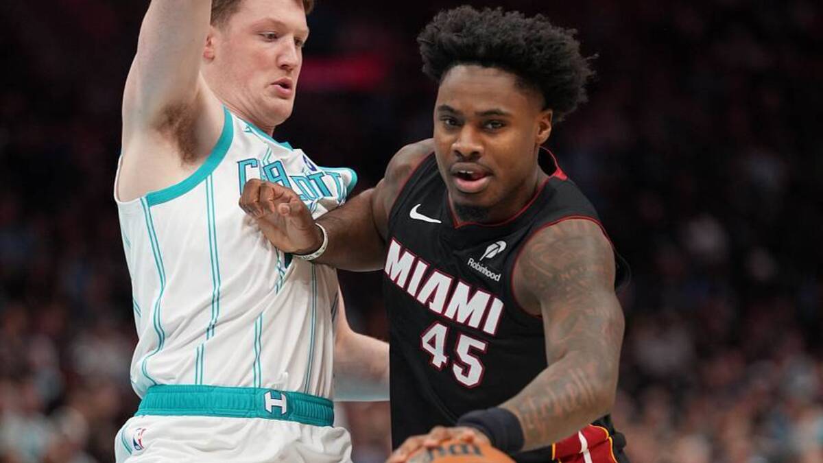  Apr 14, 2026; Charlotte, North Carolina, USA; Miami Heat guard Davion Mitchell (45) handles the ball defended by Charlotte Hornets guard/forward Kon Knueppel (7) during the first quarter during the play-in rounds between the Charlotte Hornets and the Miami Heat of the 2026 NBA Playoffs at Spectrum Center. Mandatory Credit: Jim Dedmon-Imagn Images | IMAGN IMAGES via Reuters Connect 