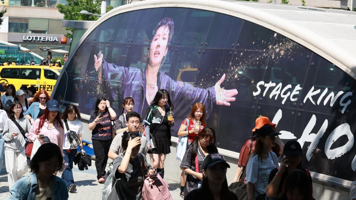 Fans stand in front of a photo of BTS member J-Hope near Busan Asiad Main Stadium, where the K-pop band will kick off the Busan leg of their "Arirang" world tour on Friday. Photo by Yonhap