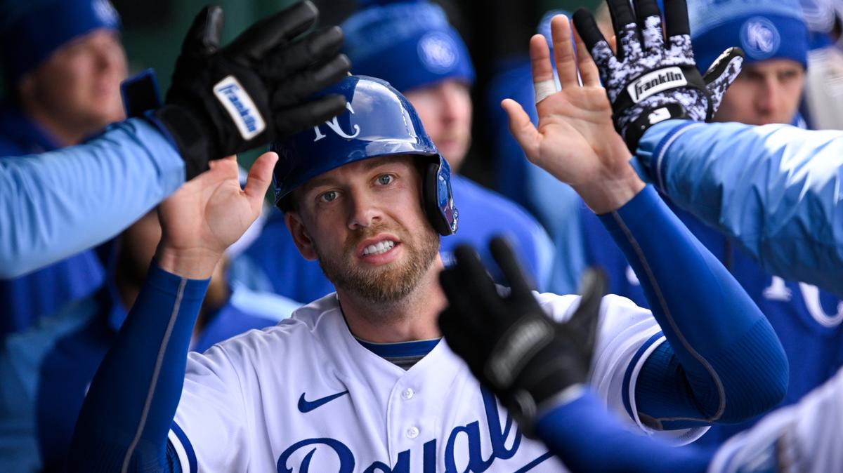 Kansas City Royals designated hitter Hunter Dozier is congratulated after scoring on a double by teammate Nicky Lopez during the fifth inning of a baseball game against the Cleveland Guardians, Thursday, April 7, 2022 in Kansas City, Mo. (AP Photo/Reed Hoffmann)