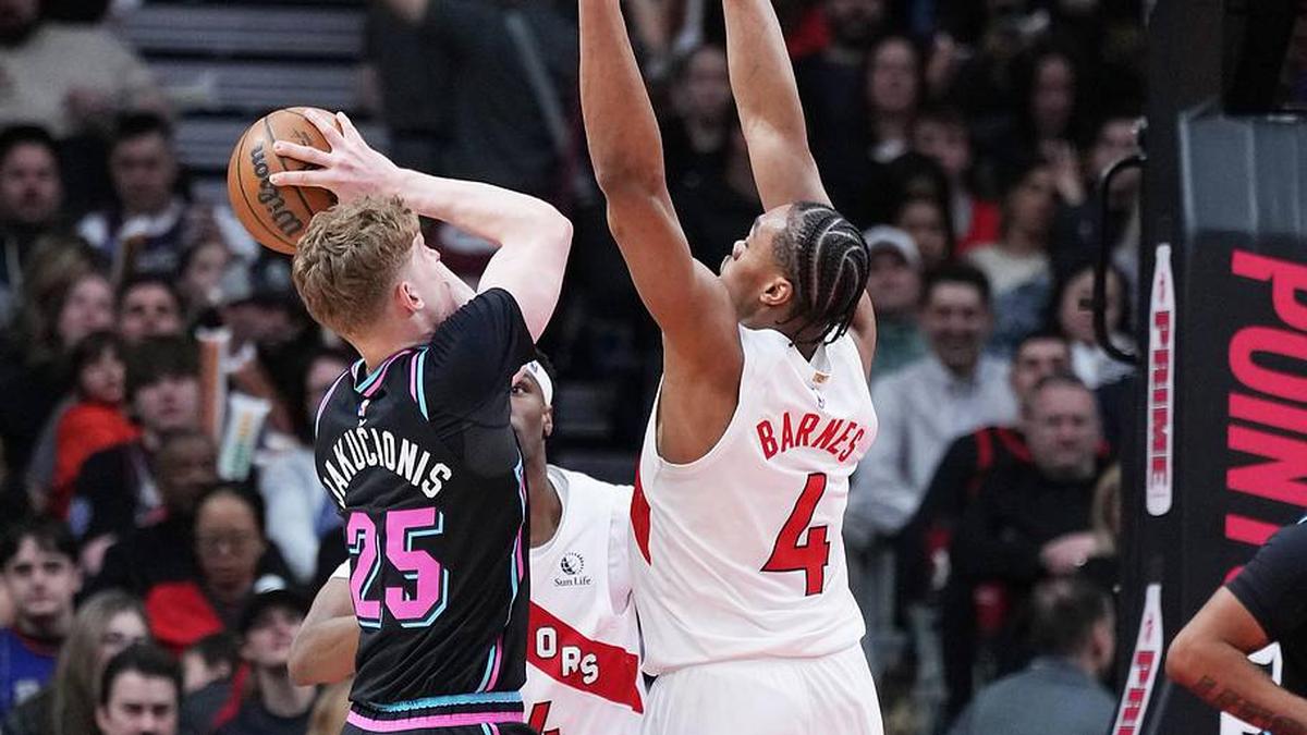  Apr 7, 2026; Toronto, Ontario, CAN; Miami Heat guard Kasparas Jakucionis (25) controls the ball as Toronto Raptors forward Scottie Barnes (4) defends during the fourth quarter at Scotiabank Arena. Mandatory Credit: Nick Turchiaro-Imagn Images | Nick Turchiaro-Imagn Images 