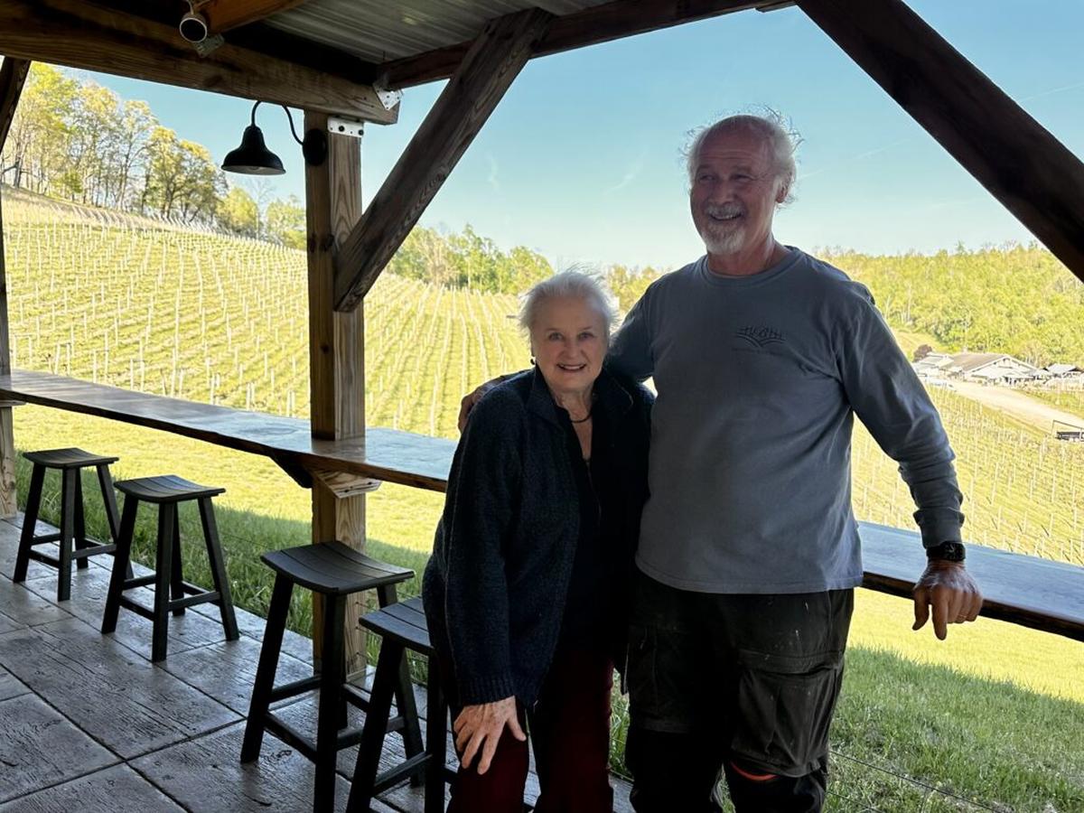 Joyce and Yvan Beliveau posing at the Sugar Shack, the new tasting room with sweeping vineyard views. Photo credit: Cathy Bennett Kopf 