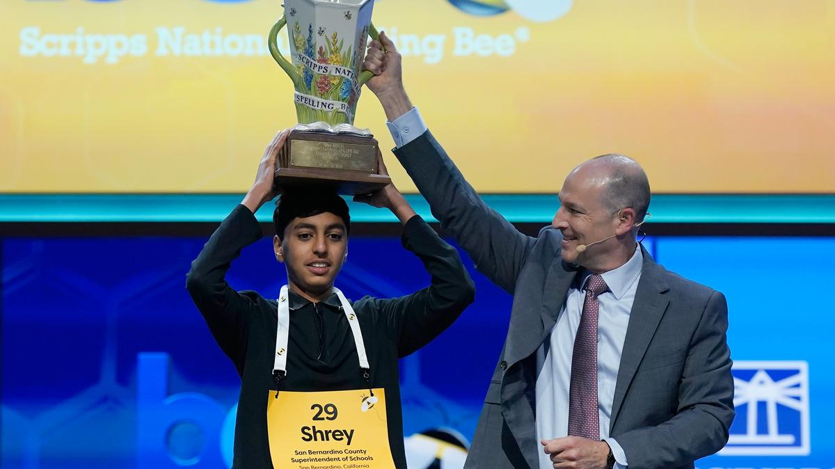 E.W. Scripps Company president and CEO Adam Symson, right, holds the trophy over winner of the 2026 Scripps National Spelling Bee, Shrey Parikh, 14, of Rancho Cucamonga, Calif., at DAR Constitution Hall, Thursday, May 28, 2026, in Washington. (AP Photo/Jose Luis Magana). 