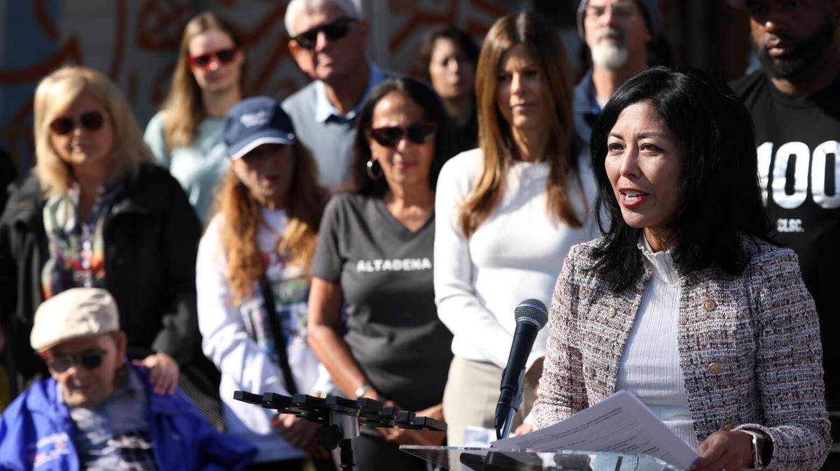ALTADENA, CA - NOVEMBER 6, 2025 -- Joy Chen, right, Executive Director of Eaton Fire Survivors Network, along with Eaton and Palisades fire survivors, urge Gov. Gavin Newsom to call for the resignation of Insurance Commissioner Ricardo Lara during a press conference at the Good Neighbor Bar in Altadena on November 6, 2025. The press conference is in response to a New York Times report revealing that Lara privately struck a deal with insurers allowing them to drop tens of thousands of policyholders ahead of the Los Angeles fires. (Genaro Molina/Los Angeles Times)