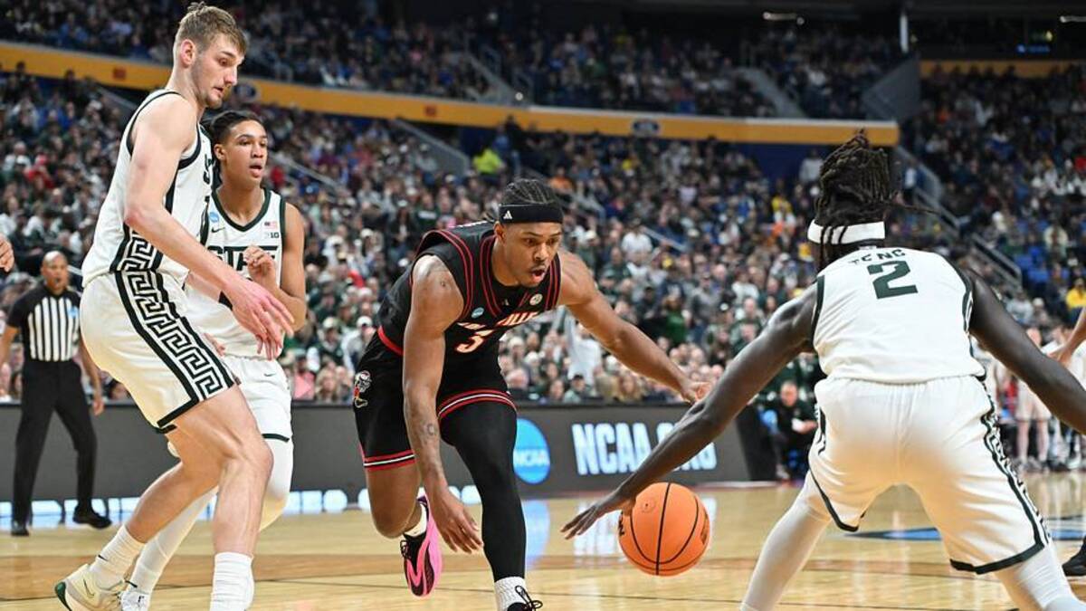  Mar 21, 2026; Buffalo, NY, USA; Louisville Cardinals guard Ryan Conwell (3) and Michigan State Spartans guard Kur Teng (2) scramble for a loose ball in the second half during a second round game of the men's 2026 NCAA Tournament at Keybank Center. Mandatory Credit: Mark Konezny-Imagn Images | IMAGN IMAGES via Reuters Connect 