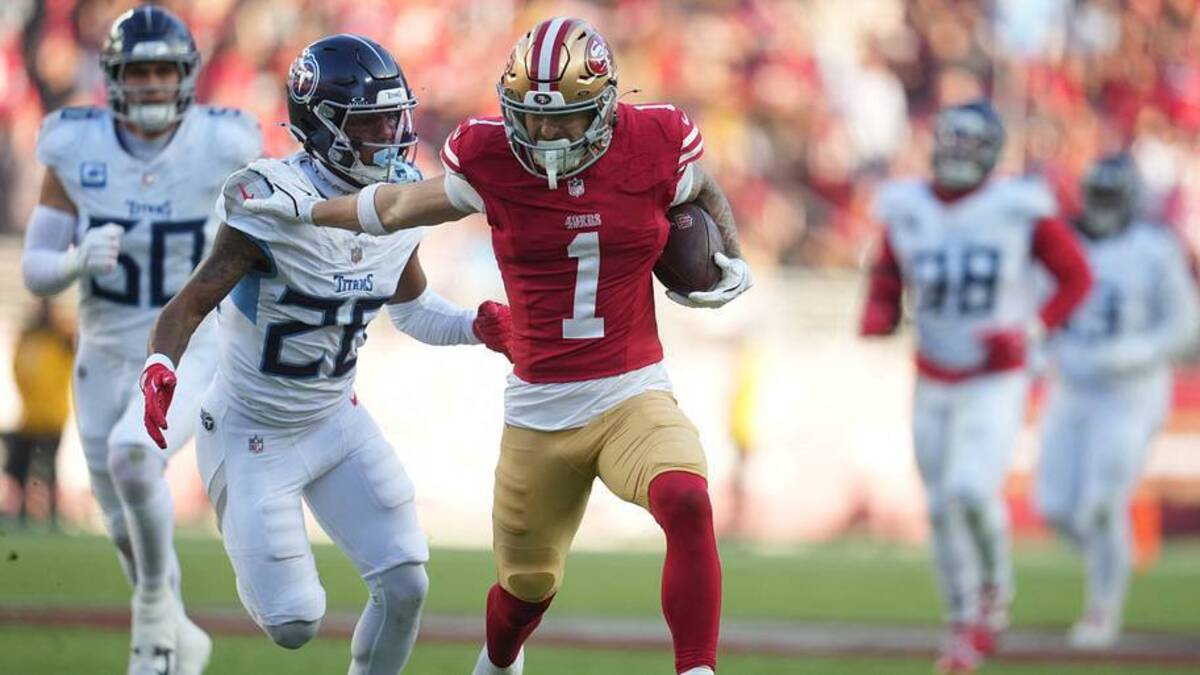  Dec 14, 2025; Santa Clara, California, USA; San Francisco 49ers wide receiver Ricky Pearsall (1) stiff arms Tennessee Titans cornerback Marcus Harris (26) during the third quarter at Levi's Stadium. Mandatory Credit: Cary Edmondson-Imagn Images | IMAGN IMAGES via Reuters Connect 