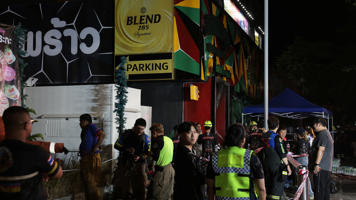 Members of emergency personnel work at the site of a deadly fire at a pub in Bangkok, Thailand, July 13, 2026. REUTERS/Chalinee Thirasupa