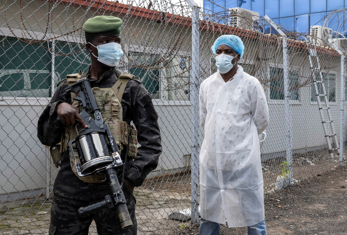 A member of the M23 rebel group stands guard as provincial authorities visit the Rodolphe Merieux Laboratory, National Biomedical Research Institute (INRB), where samples from suspected Ebola cases are tested, as part of the response to the epidemic in Goma, North Kivu province of the Democratic Republic of Congo, May 19, 2026. REUTERS/Arlette Bashizi