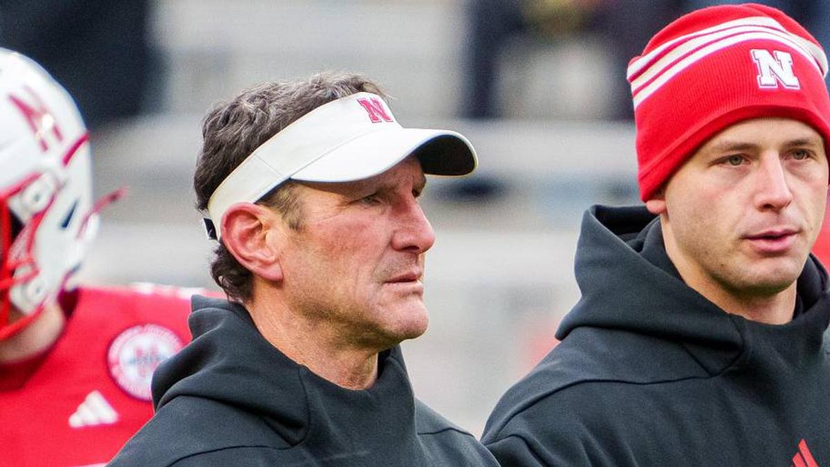  Nov 28, 2025; Lincoln, Nebraska, USA; Nebraska Cornhuskers assistant coach Mike Ekeler (left) watches warmups before the game against the Iowa Hawkeyes at Memorial Stadium. Mandatory Credit: Dylan Widger-Imagn Images | Dylan Widger-Imagn Images 