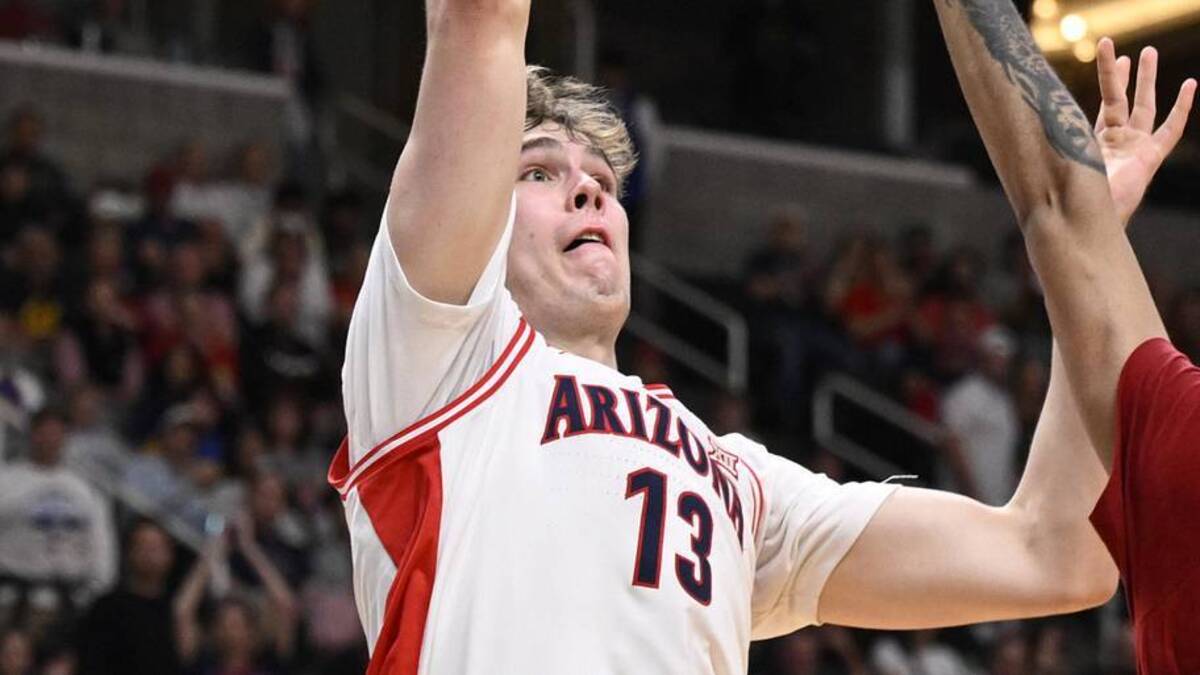  Mar 26, 2026; San Jose, CA, USA; Arizona Wildcats center Motiejus Krivas (13) shoots over Arkansas Razorbacks forward Malique Ewin (12) in the first half during a Sweet Sixteen game of the West Regional of the men's 2026 NCAA Tournament at SAP Center. Mandatory Credit: Eakin Howard-Imagn Images | Eakin Howard-Imagn Images 