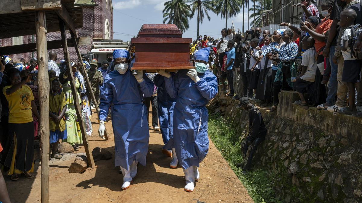 Health workers carry a coffin with the body of Rev. Sylvestre Atama, a popular and charismatic preacher who died of Ebola in the mining town of Mongbwalu, Democratic Republic of Congo, May 25, 2026. In a remote gold mining town at the epicenter of the Ebola outbreak, medical workers struggle to beat back a surge of deaths and infections. (Arlette Bashizi/The New York Times)