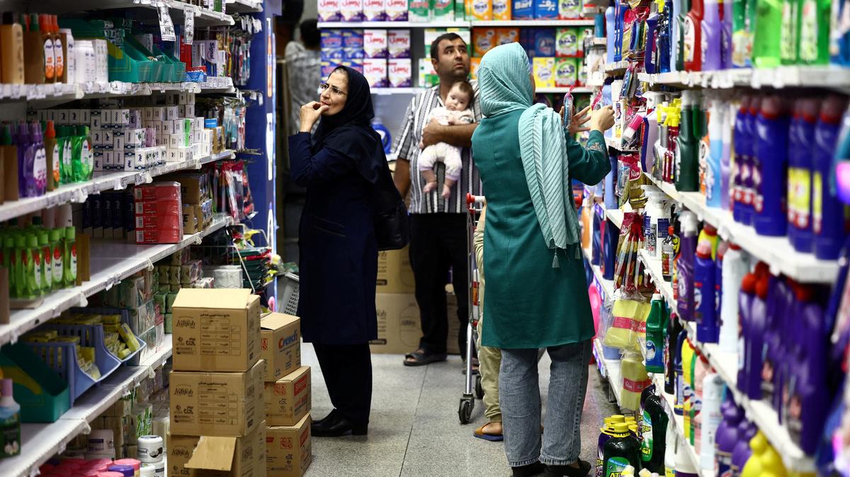 People shop in a store in Tehran, Iran, on Tuesday. The Islamic Republic looks able to survive a standoff in the Persian Gulf for now, despite a U.S. blockade that has cut off energy exports.