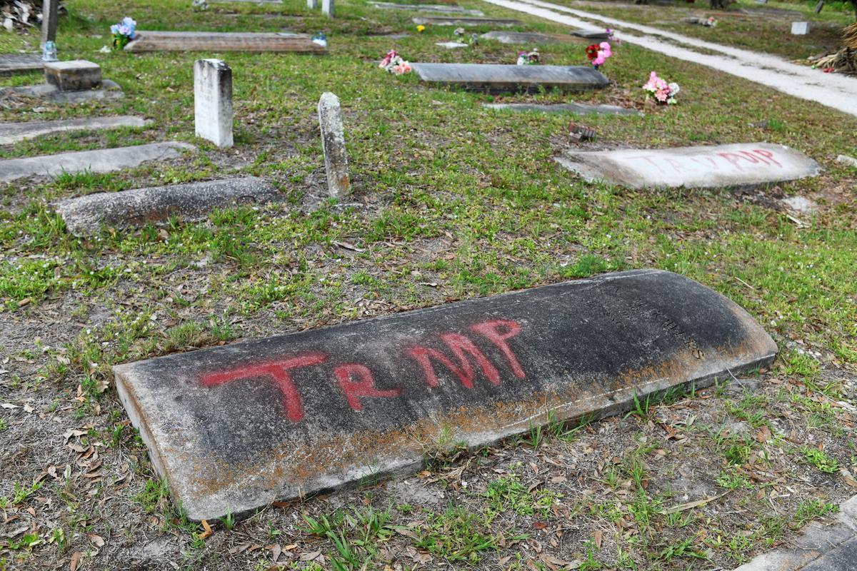 A spray-painted grave at The Old Memphis Cemetery, a predominantly African-American cemetery, after the place was vandalized, with 17 gravesites and several headstones damaged in Palmetto, Florida, U.S., May 14, 2026. Authorities say “Trump” and “DeSantis” were spray-painted in red across several tombs as police continue investigating the incident. REUTERS/Octavio Jones
