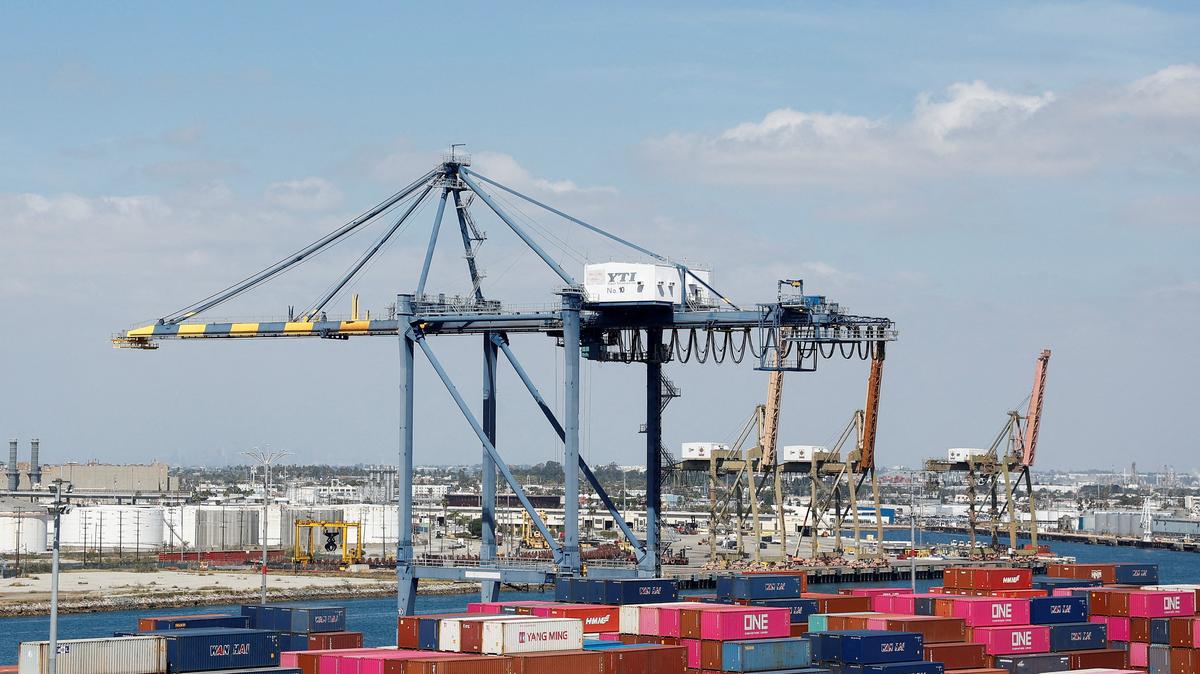 FILE PHOTO: Shipping containers are stacked at a terminal at the port of Los Angeles in Long Beach, California, U.S., March 10, 2026. REUTERS/Caroline Brehman/File Photo