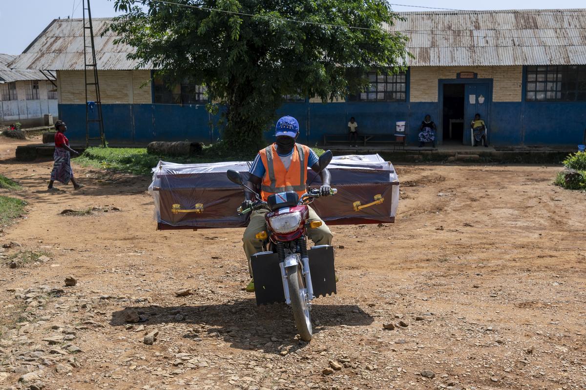 A motorcyclist transports Christiane Bahati's coffin in the mining town of Mongbwalu, which is at the epicenter of the Ebola virus outbreak in Democratic Republic of Congo, May 27, 2026. In a remote gold mining town at the epicenter of the Ebola outbreak, medical workers struggle to beat back a surge of deaths and infections. (Arlette Bashizi/The New York Times)