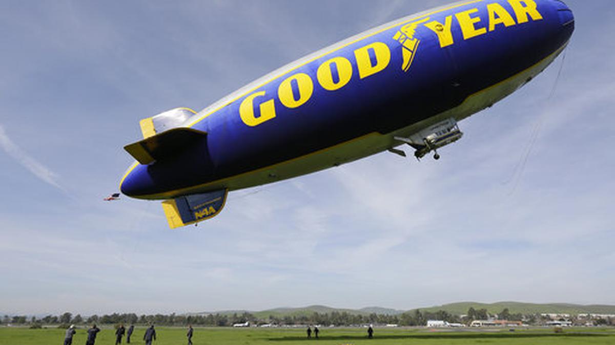 FILE - In this Friday, Feb. 5, 2016, file photo, the Goodyear Blimp Spirit of Innovation takes off for a flight over Super Bowl fan sites from the airport in Livermore, Calif. As a nod to its influence and legacy to the game, the iconic airship is being inducted into the College Football Hall of Fame as an honorary member — the first non-player or coach to be inducted. The blimp’s flight to fame began during the telecast for the 1955 Rose Bowl Game and has led to it being an eye in the sky at over 2,000 games, hovering above stadiums from coast to coast.